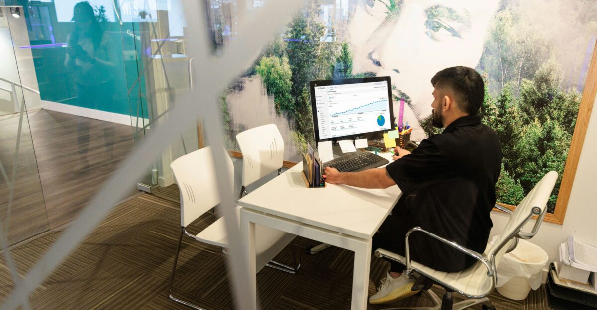 a man sitting at a desk working on a computer