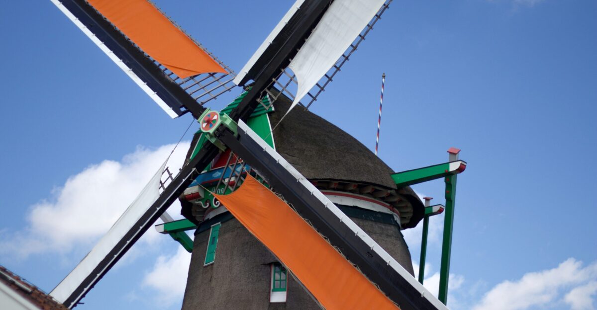 a windmill with a flag on top of it