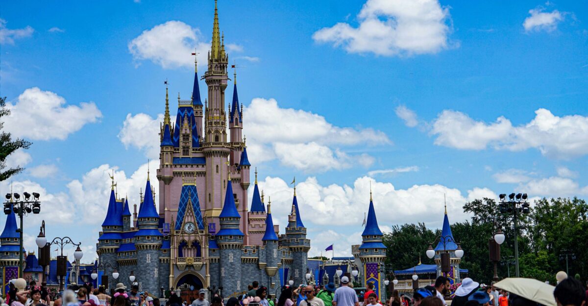A crowd of people standing in front of a castle