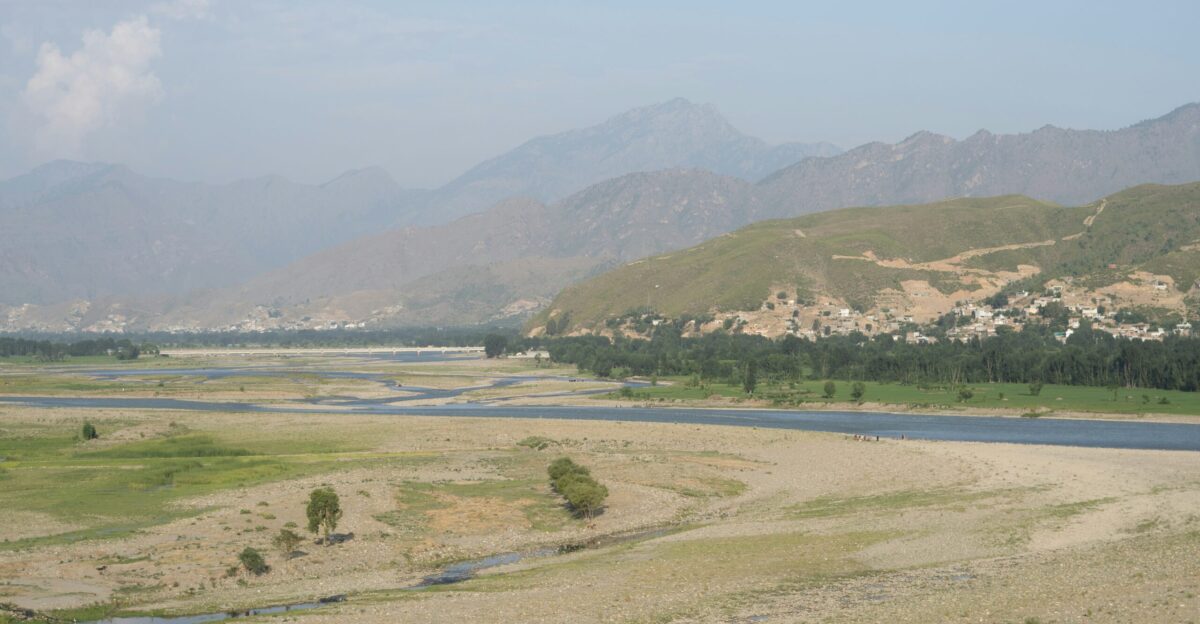 A river running through a lush green valley