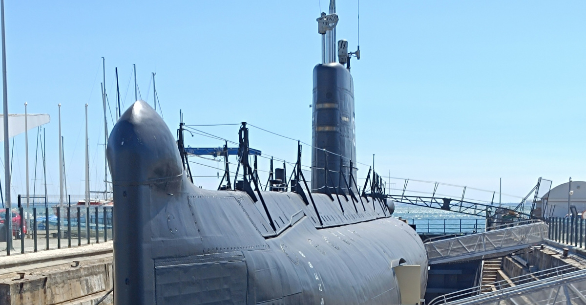 A submarine sitting on top of a wooden dock