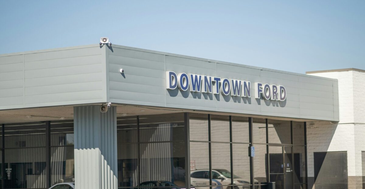 A car dealership with cars parked in front of it