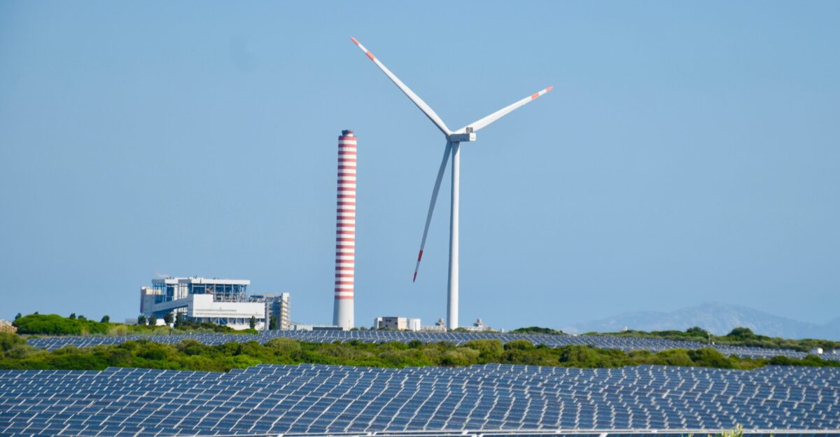 A wind farm with a wind turbine in the background