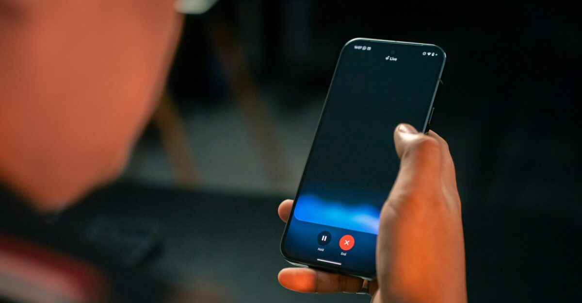 A person holding a cell phone in their hand