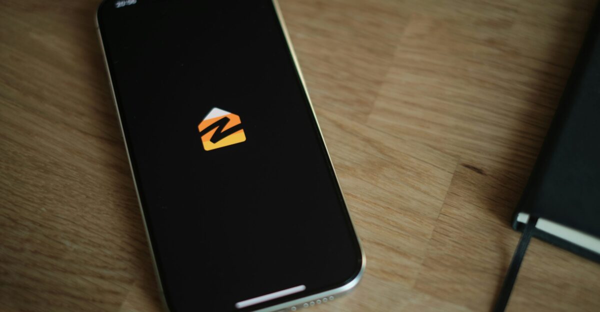 A cell phone sitting on top of a wooden table