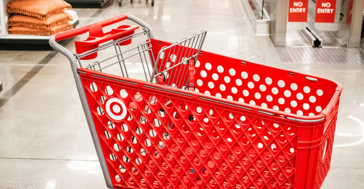 A red target shopping cart sits in a store