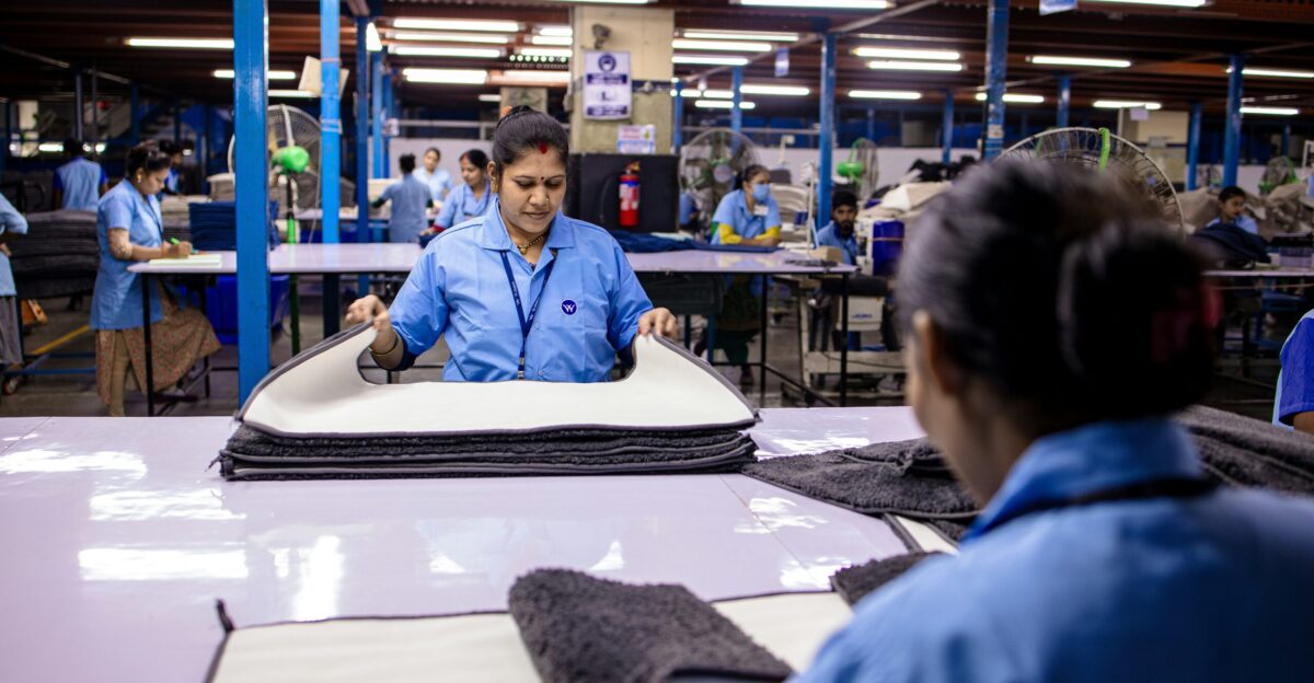 Workers are busy assembling materials in a factory
