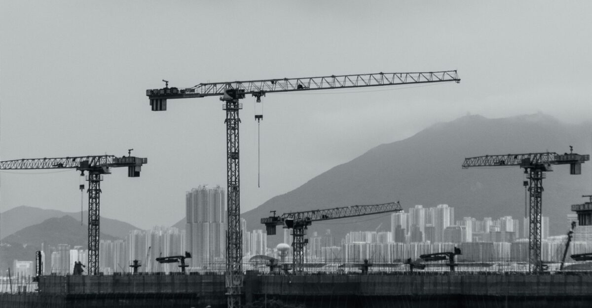 Construction cranes populate the cityscape