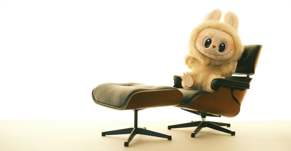 A cute stuffed animal sits on a comfortable chair