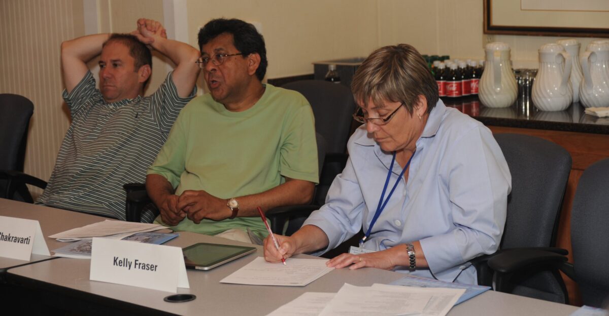 Planning the Future of Genomics Foundational Research and Applications in Genomic Medicine meeting July 2010 David Altshuler Aravinda Chakravarti Kelly Fraser at table Airlie Conference Center Warrenton Virginia