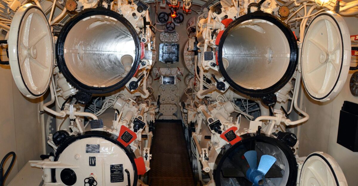 Detailed interior view of a submarine s torpedo room with open hatches