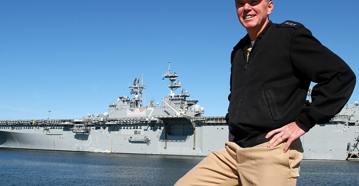 Naval Station Norfolk Va Nov 15 2004 - Commander U S Second Fleet NATO Striking Fleet Atlantic Vice Adm Mark P Fitzgerald views the waterfront aboard the Worlds largest Naval Base Pictured behind Vice Adm Fitzerald is the amphibious assault ship USS Iwo Jima LHD 7 which is currently serving as the 2nd Fleet flagship U S Navy photo by Photographer s Mate 2nd Class Gregory Roberts RELEASED