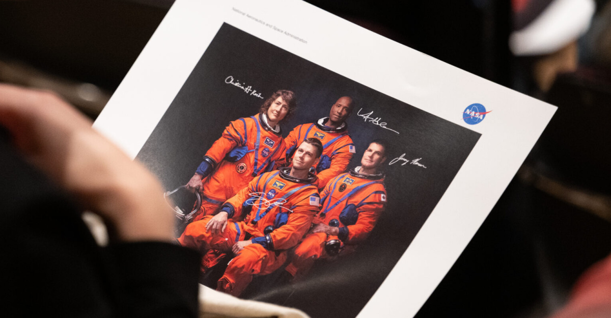 An employee of NASA’s Goddard Space Flight Center holds a photograph of NASA’s Artemis II crew, Friday, May 19, 2023, during an employee engagement event at NASA’s Goddard Space Flight Center in Greenbelt, Md. NASA astronauts Reid Wiseman, Victor Glover, Christina Hammock Koch, and CSA (Canadian Space Agency) astronaut Jeremy Hansen, who will fly around the Moon on NASA’s Artemis II flight test, visited Washington to discuss their upcoming mission with members of Congress and others. Photo Credit: (NASA/Joel Kowsky)