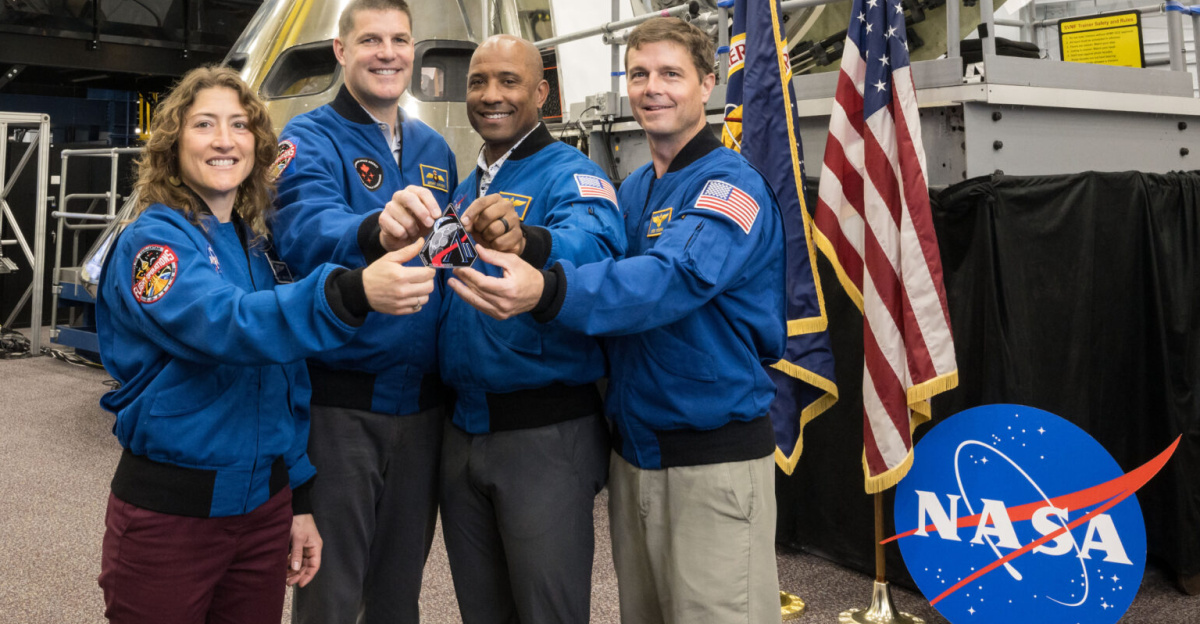 jsc2025e034750 (April 2, 2025) -- Artemis II crew with the Artemis II mission patch. Photo Credit: NASA/Robert Markowitz