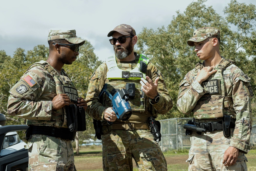 Royal Australian Air Force Military police officer Cpl Raymond Tyson teaches a class on radar speed detection to U S Army Spc Johnathan Rojas and Sgt Rashan Paige military police officers assigned to the 8th Military Police Brigade during Exercise Talisman Sabre 25 in Queensland Australia July 17 2025 Talisman Sabre is the largest bilateral military exercise between Australia and the United States with multinational participation advancing a free and open Indo-Pacific by strengthening relationships and interoperability among key allies and enhancing our collective capabilities to respond to a wide array of potential security concerns U S Army photo by Sgt Raven Jones