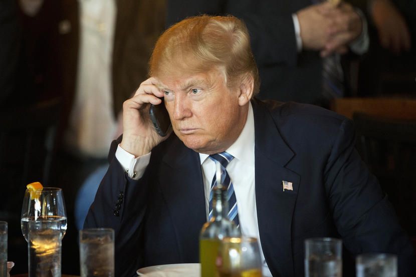 Republican presidential candidate Donald Trump listens to his mobile phone during a lunch stop Feb 18 2016 in North Charleston S C Photo by Matt Rourke AP by P Scoville