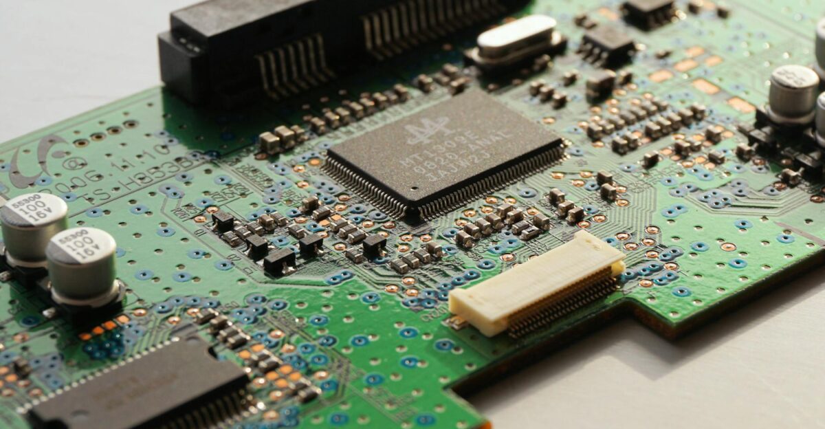 Detailed close-up photo of a circuit board highlighting microchip components and electronic circuits