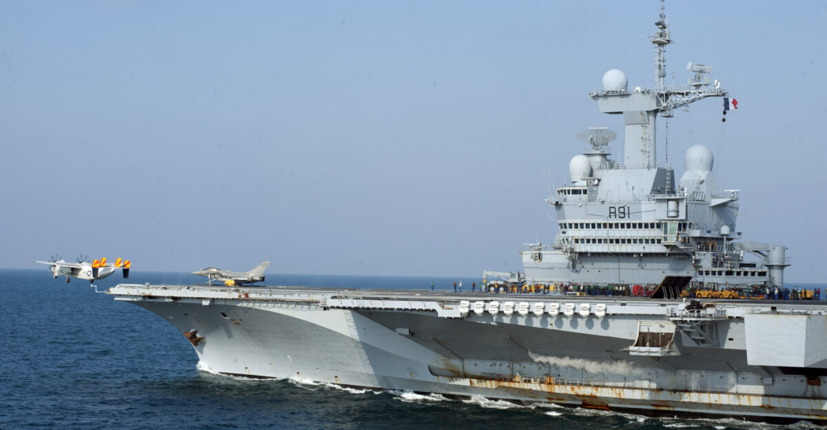 A U S Navy Grumman C-2A Greyhound assigned to Fleet Logicstics Support Squadron VRC-40 Det 4 Rawhides aboard the U S Navy aircraft carrier USS Harry S Truman CVN-75 launches from the French aircraft carrier Charles de Gaulle R91 in the Gulf of Oman Charles de Gaulle flagship for the French Task Force 473 was conducting operations with the Harry S Truman Carrier Strike Group
