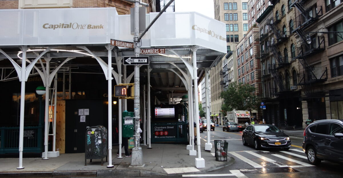 Fancy scaffolding about the ground level of the Gerken Building 90 West Broadway at the southwest corner of Chambers Street and West Broadway in Tribeca Manhattan Here the banners advertise the Capital One branch inside the building