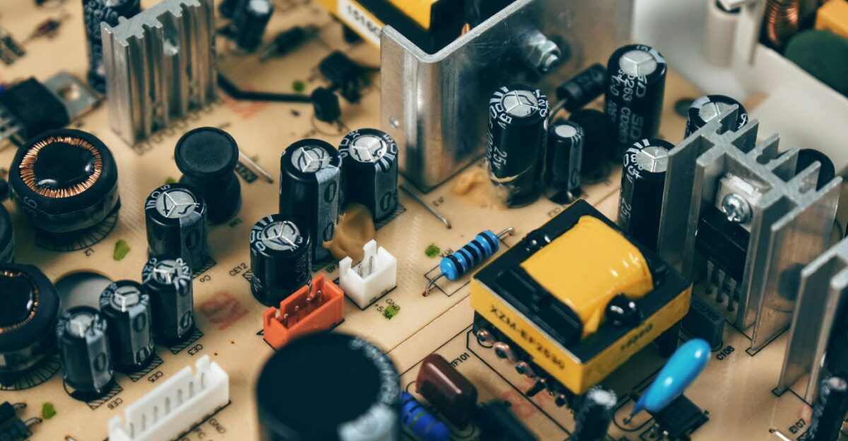 Detailed shot of capacitors and resistors on a circuit board showcasing modern technology