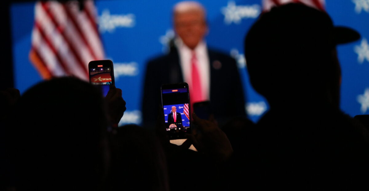 Crowd taking photos of Donald Trump on their phones at CPAC 2025