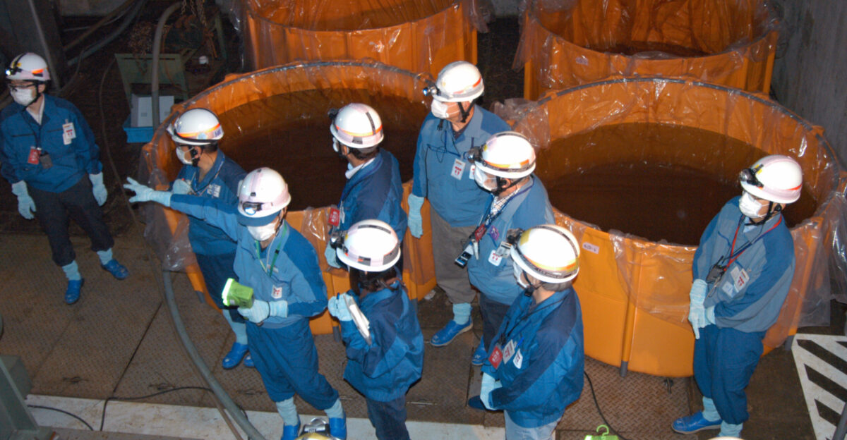 Members of the IAEA fact-finding team in Japan examine the diesel generator room at Unit 1 of the Fukushima Daini Nuclear Power Plant on 26 May 2011 The room was flooded by seawater during the 11 March tsunami and Japanese workers have transferred the water into the containers shown Copyright IAEA Imagebank Photo Credit Greg Webb IAEA