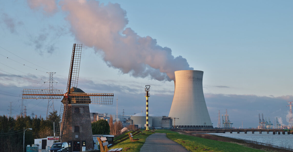 De Molen windmill and the nuclear power plant cooling tower in Doel Belgium
