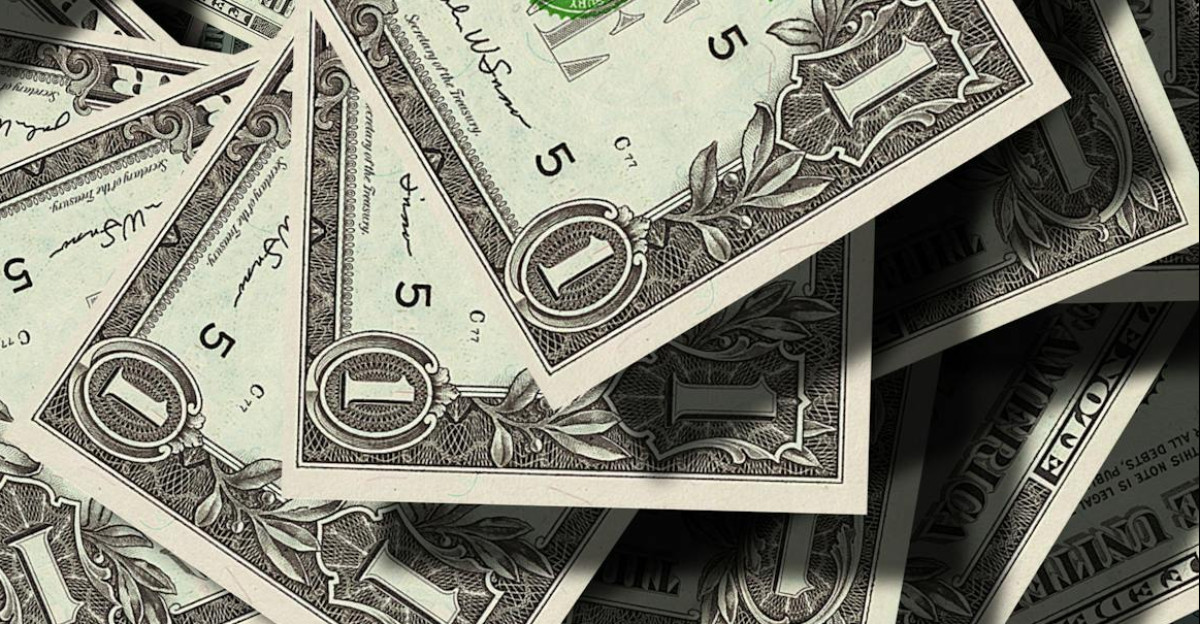 Close-up of scattered US dollar bills symbolizing finance and wealth