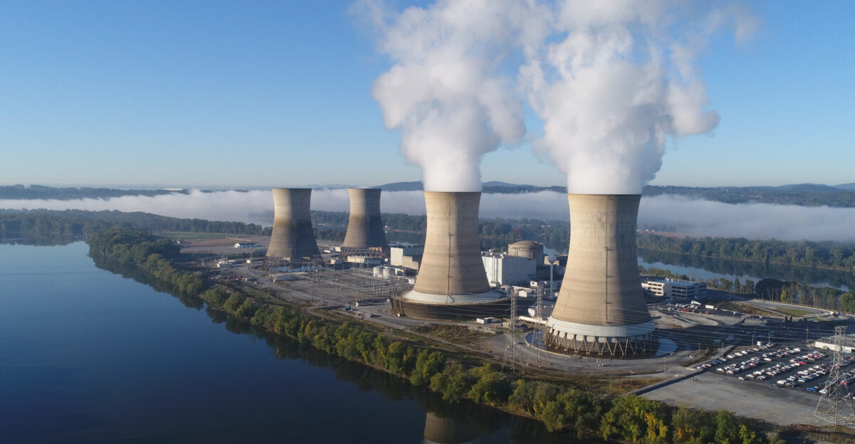 The working cooling towers of Exelon Generation Unit 1 in the foreground are emitting water vapor The dormant cooling towers are from Unit 2 which was permanently damaged in the 1979 accident