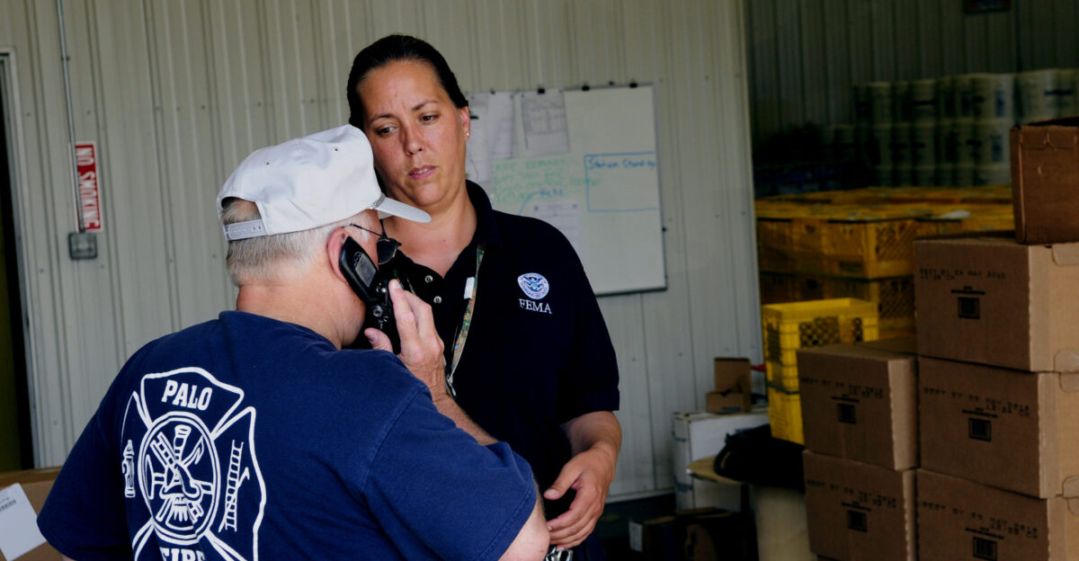 Palo IA June 20 2008 - Lesley Pearson FEMA Application Assistant from New Hampshire works with Palo Fire Chief Steve Mason in resolving a residence request during flooding recovery in Linn County Iowa Barry Bahler FEMA