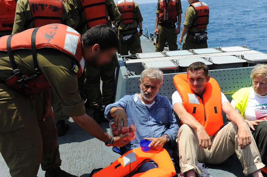Following the Israel Navy s interception of the Free Gaza Movement s Al-Karama ship which sought to break the naval blockade surrounding the Gaza Strip Navy soldiers hand out food and water to the passengers aboard the ship