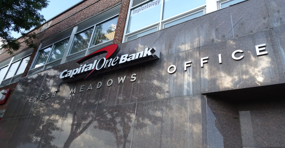 Looking at the Capital One Bank at the center of Building I from the parking lot in the western half of the Fresh Meadows Place Shopping Center at 188th Street and 64th Avenue in Fresh Meadows Queens The bank retains the original stone granite facade from the 1949 Jamaica Savings Bank Much like the small shopping center at 73rd Avenue the shops in the building have entrances on both sides