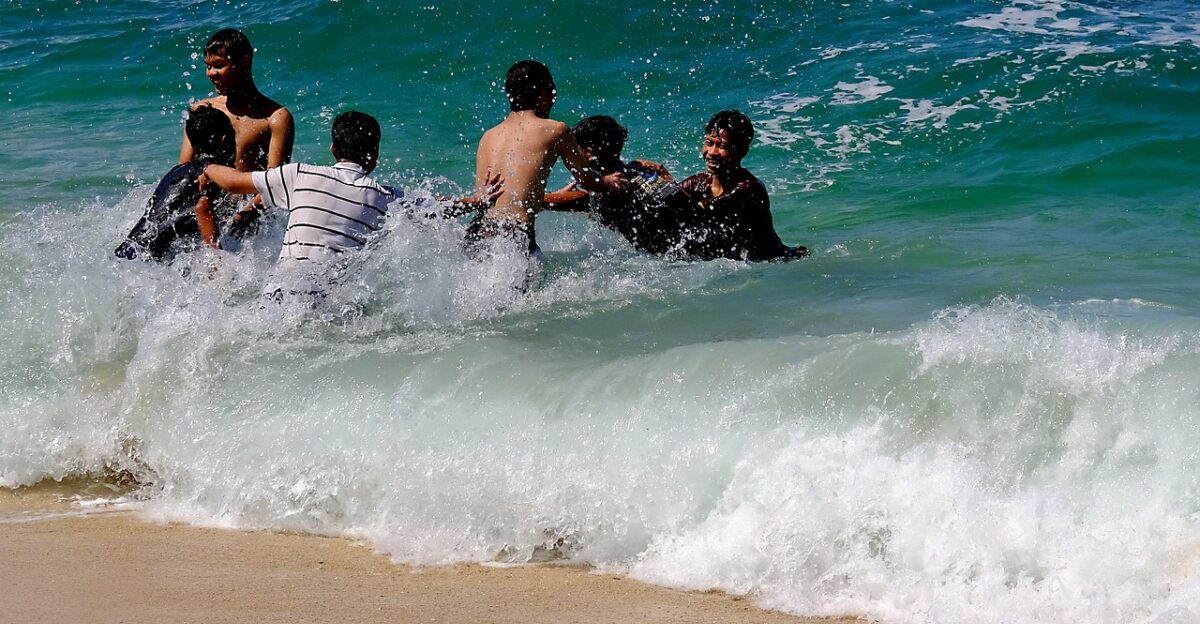 beach wave sea nature ocean playing at beach young men people