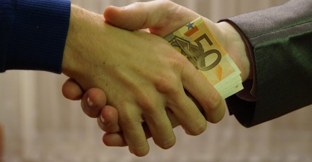 euro bank notes hand shake transaction people shaking hands fifty 50 euros purchase sale trade under the table hands of businessmen man suit finances pay silver debt money investment bank note banker commercial attach trader business businessman repayment loan to borrow european currency pack of bills to treat market financial transaction commercial ok contract banker banker banker banker banker trader repayment repayment repayment loan loan