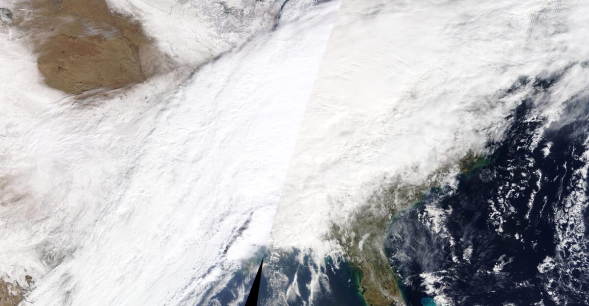 A winter storm spanning nearly 2 000 miles 3 000 kilometers brought bitter cold temperatures heavy snow freezing rain and treacherous ice to more than dozen states during the first week of February 2022 The storm began on February 1 with a cold front surging from the Rockies to the Midwest and bringing extreme cold and heavy snow By week s end the storm had cut a massive swath across the country from Texas to Maine The National Weather Service reported temperatures ranging 15 to 30 degrees below average across the Plains and Ohio Valley Freezing rain and sleet coated roads and trees bringing down power lines and causing extensive power outages thousands of flight cancellations and hazardous travel conditions The potent front also stirred up a tornado in Alabama amid heavy rainfall and flooding As of February 4 dozens of cities had reported snow totals in the double digits and wind chill and hard freeze advisories remained in effect in many areas The extensive cloud cover associated with the storm appears in this true-color image acquired by the Moderate Resolution Imaging Spectroradiometer MODIS on board NASA s Terra satellite on February 3 2022 The vast storm closely followed a blizzard from which millions of people from North Carolina to Maine were still digging out