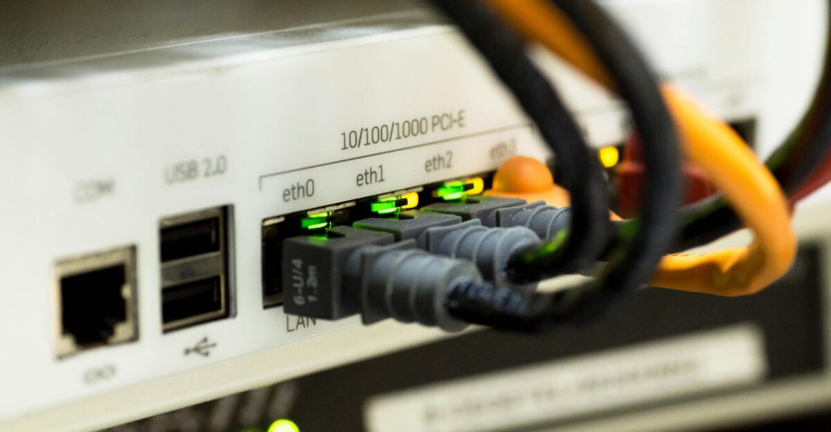 Detailed close-up of ethernet cables and network connections on a router showcasing modern technology