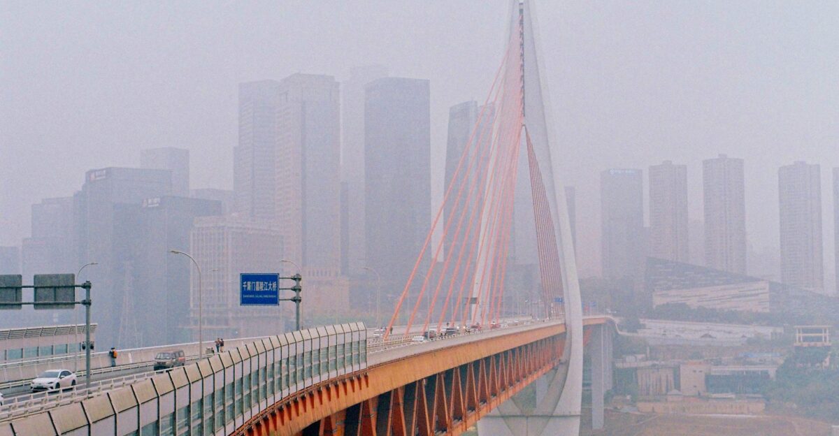 Chongqing cityscape featuring a bridge and skyscrapers enveloped in fog