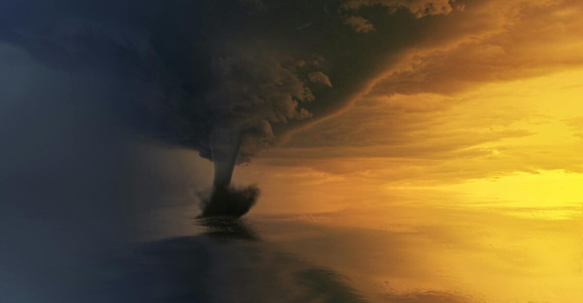 A powerful tornado over the ocean during a dramatic sunset capturing the storm s intensity and beauty