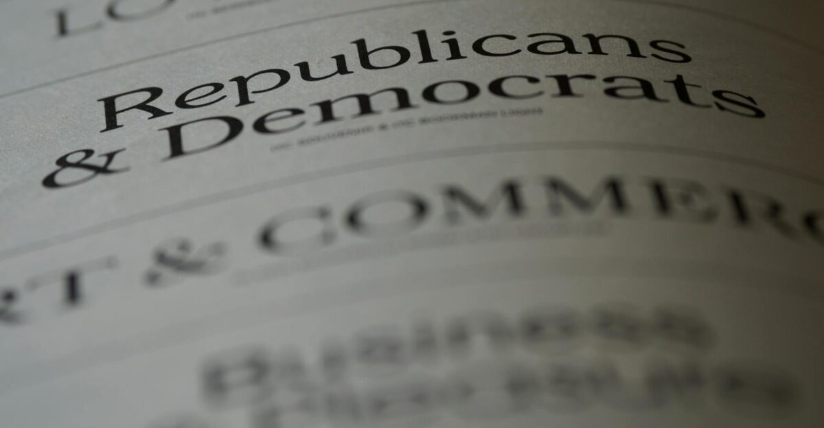 Close-up of blurred text page with Republicans Democrats focusing on political themes