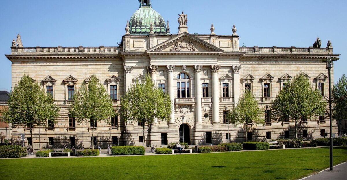 Front view of the Federal Administrative Court in Leipzig Germany with a green lawn and clear sky
