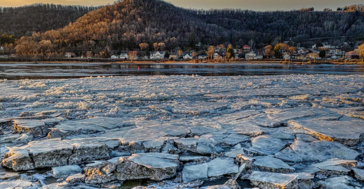 Frozen lake with snow-covered hills and trees in Reads Landing MN