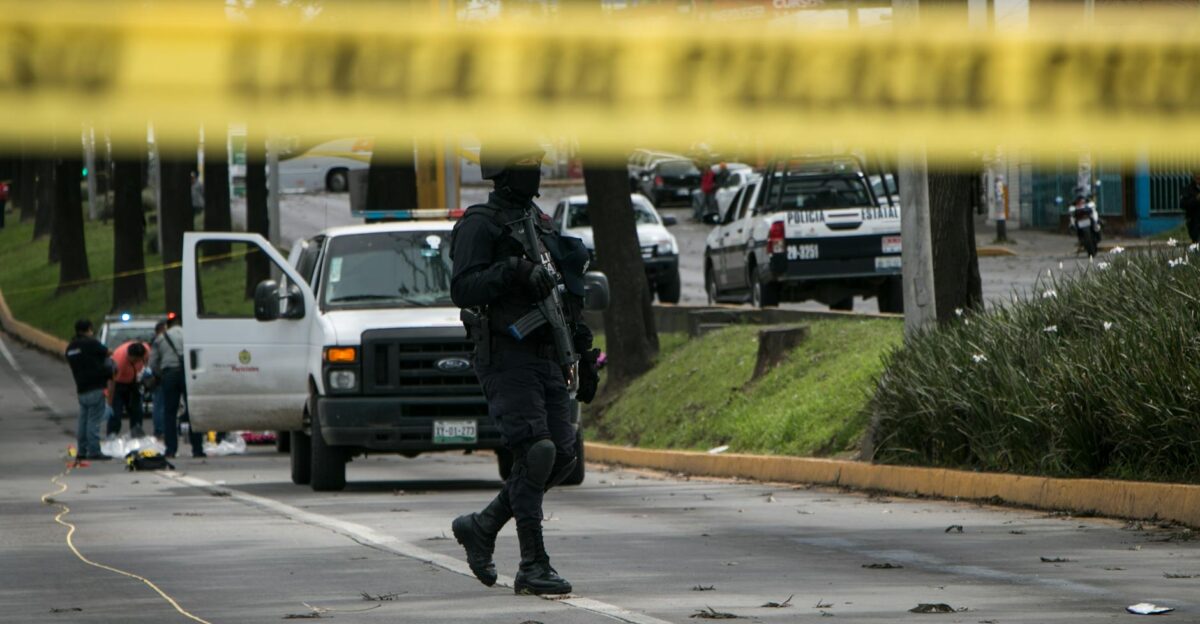 Police officers investigate and secure a crime scene in an urban street with caution tape