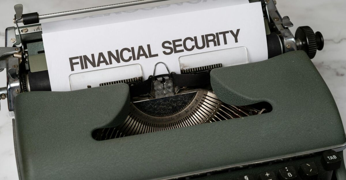 Close-up of a vintage typewriter with Financial Security typed on paper representing financial themes