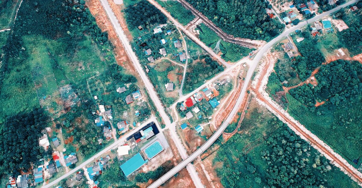 A captivating aerial shot of a rural town with winding roads houses and lush greenery