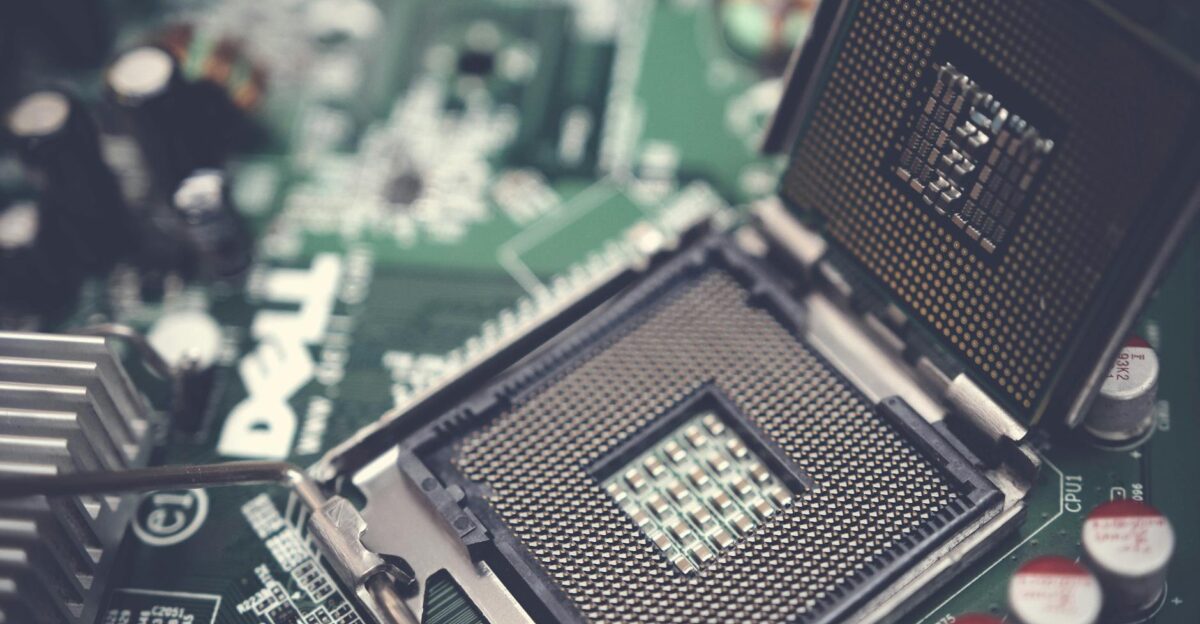 Detailed view of a CPU socket on a green motherboard showcasing microprocessor technology