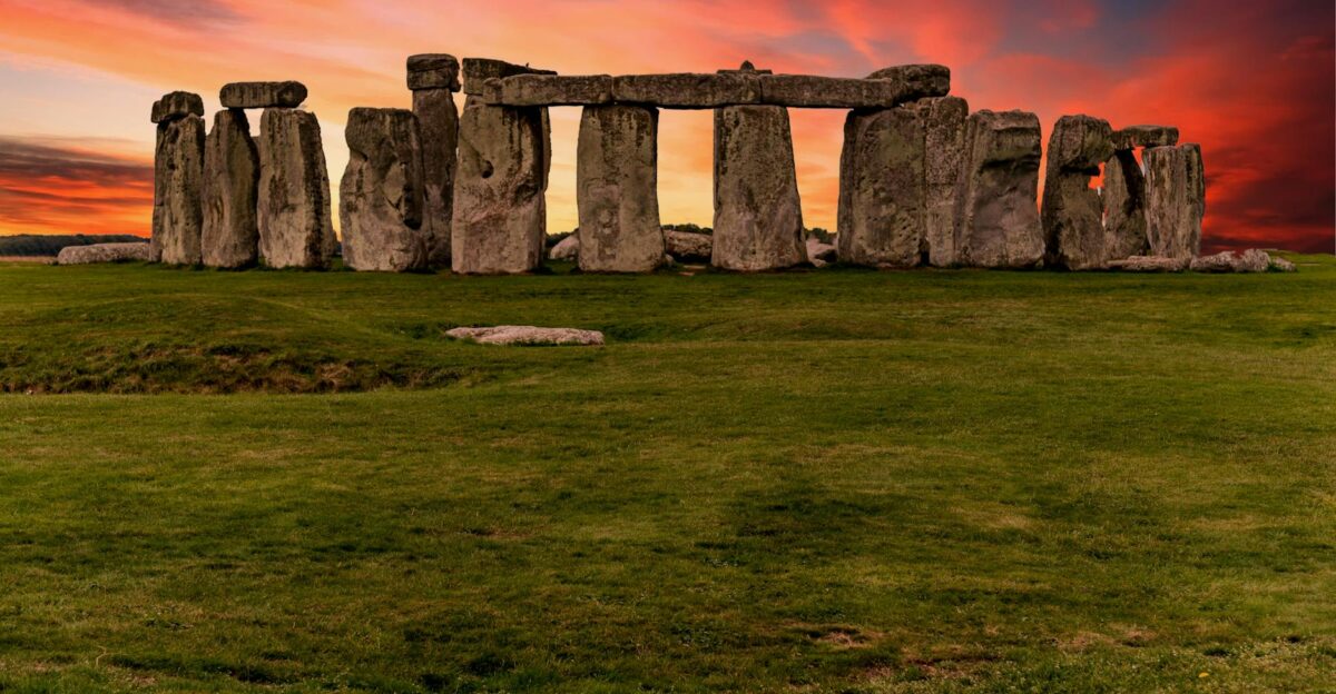 Capture of the iconic Stonehenge during a vibrant sunset with a dramatic sky