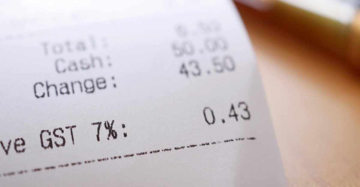 Detailed close-up image of a shopping receipt showing GST and total changes