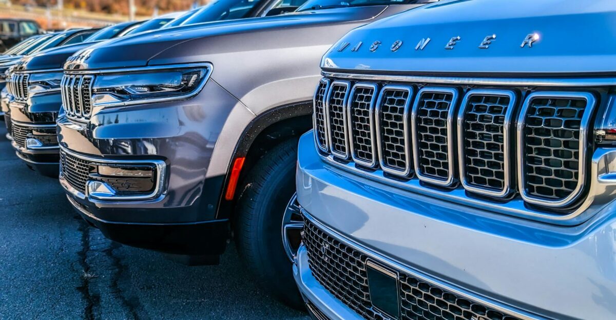 Close-up view of modern SUVs parked in a dealership lot