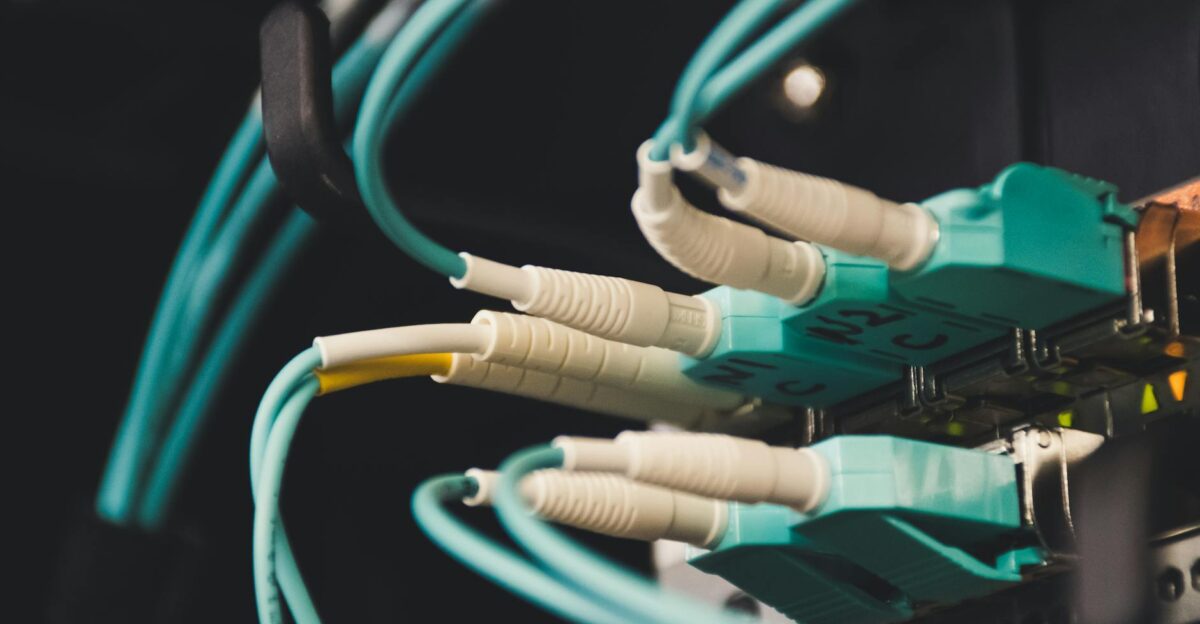 Detailed view of fiber optic cables and ports in a server room showcasing connectivity
