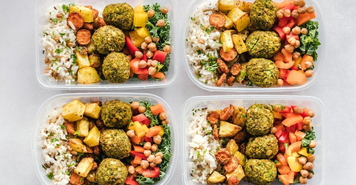 Colorful meal prep containers with falafel chickpeas rice and vegetables for a healthy lifestyle